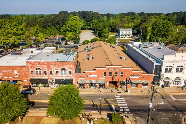 Aerial view of historic brick storefronts along a downtown street in Apex, NC