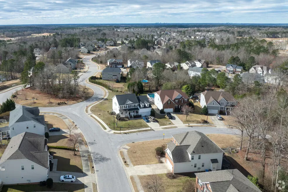 Aerial view of a residential neighborhood with tree-lined streets in Rolesville, NC